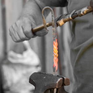 blacksmith twisting molten metal